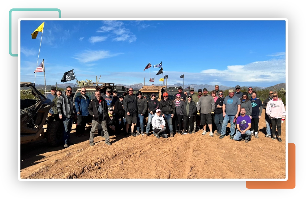 A group of people standing in the dirt.