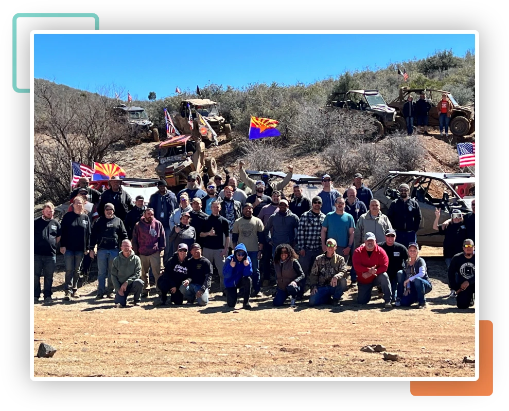 A group of people standing in the dirt.