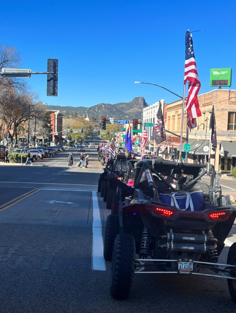 A row of motorcycles driving down the street.