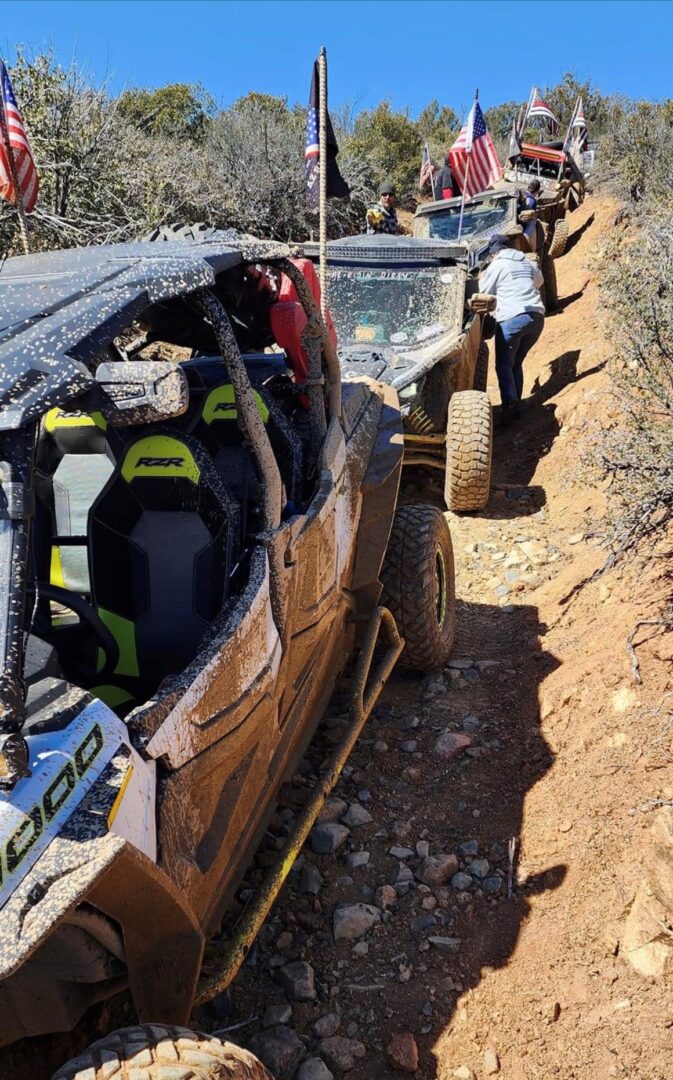 A jeep is parked on the side of a dirt road.