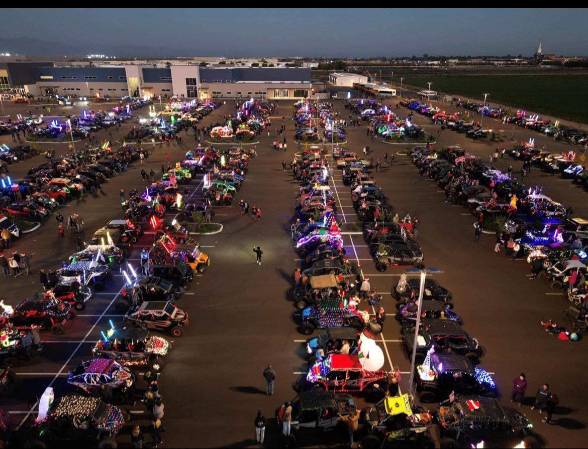 A large group of people in an open parking lot.