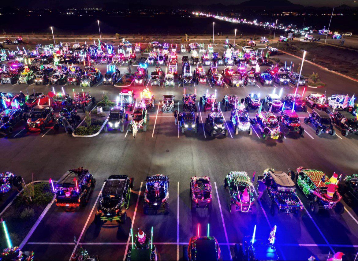 A parking lot filled with lots of cars at night.