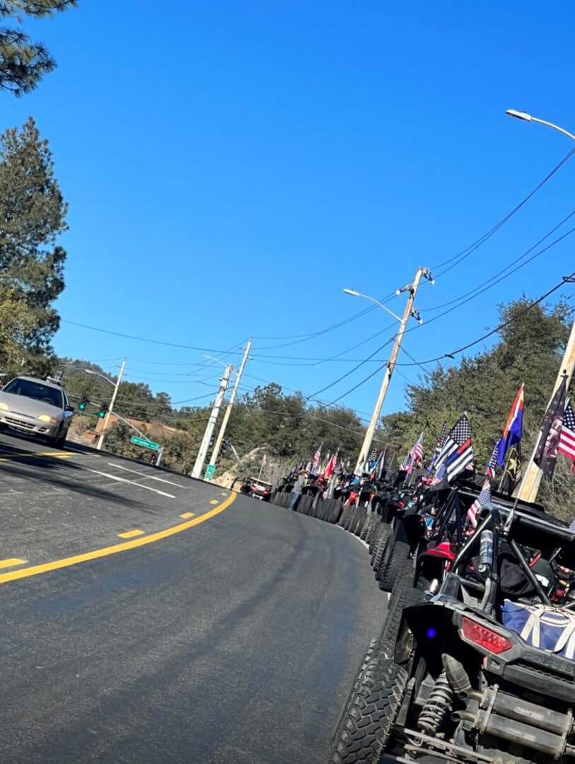 A group of motorcycles driving down the street.