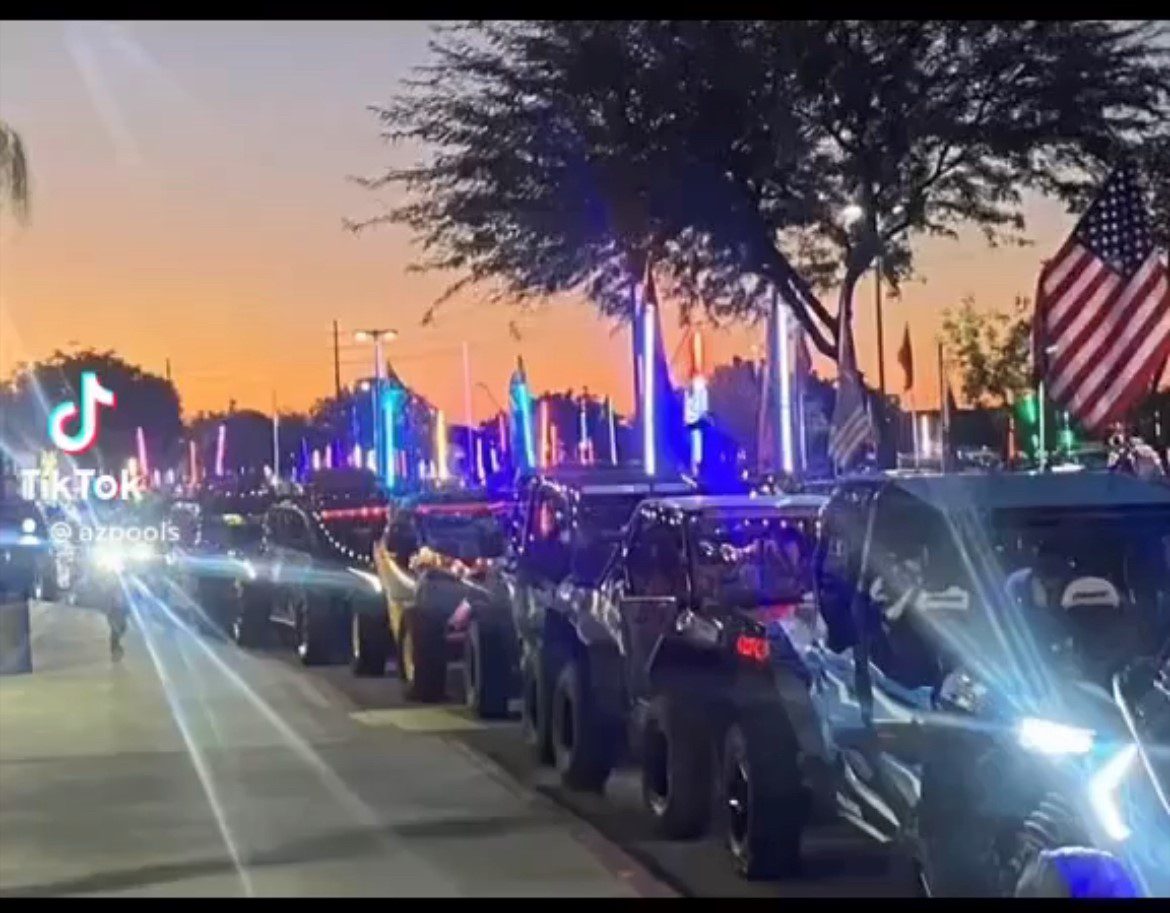 A line of atvs parked on the side of a road.