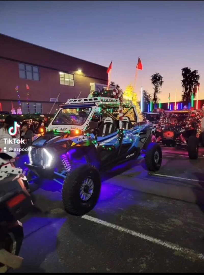 A group of people in the street with a vehicle.