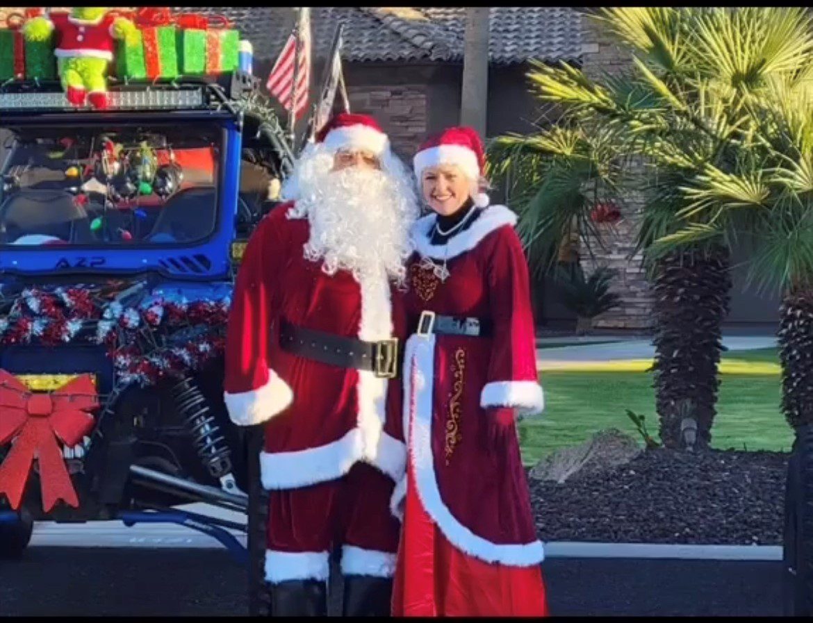 A man and woman dressed as santa clause