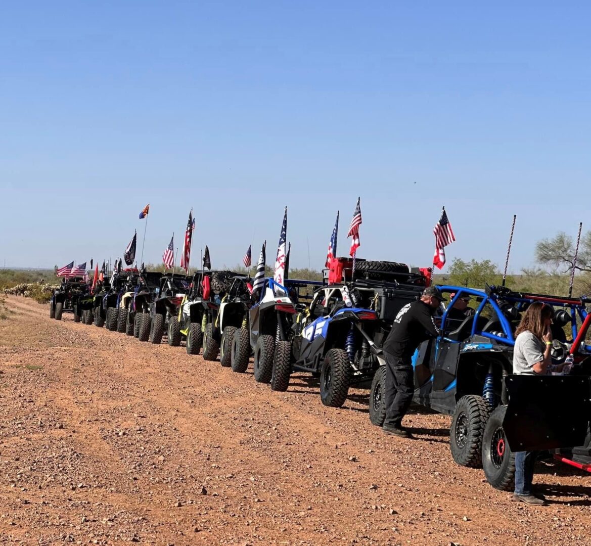 A group of people riding atvs on top of dirt.