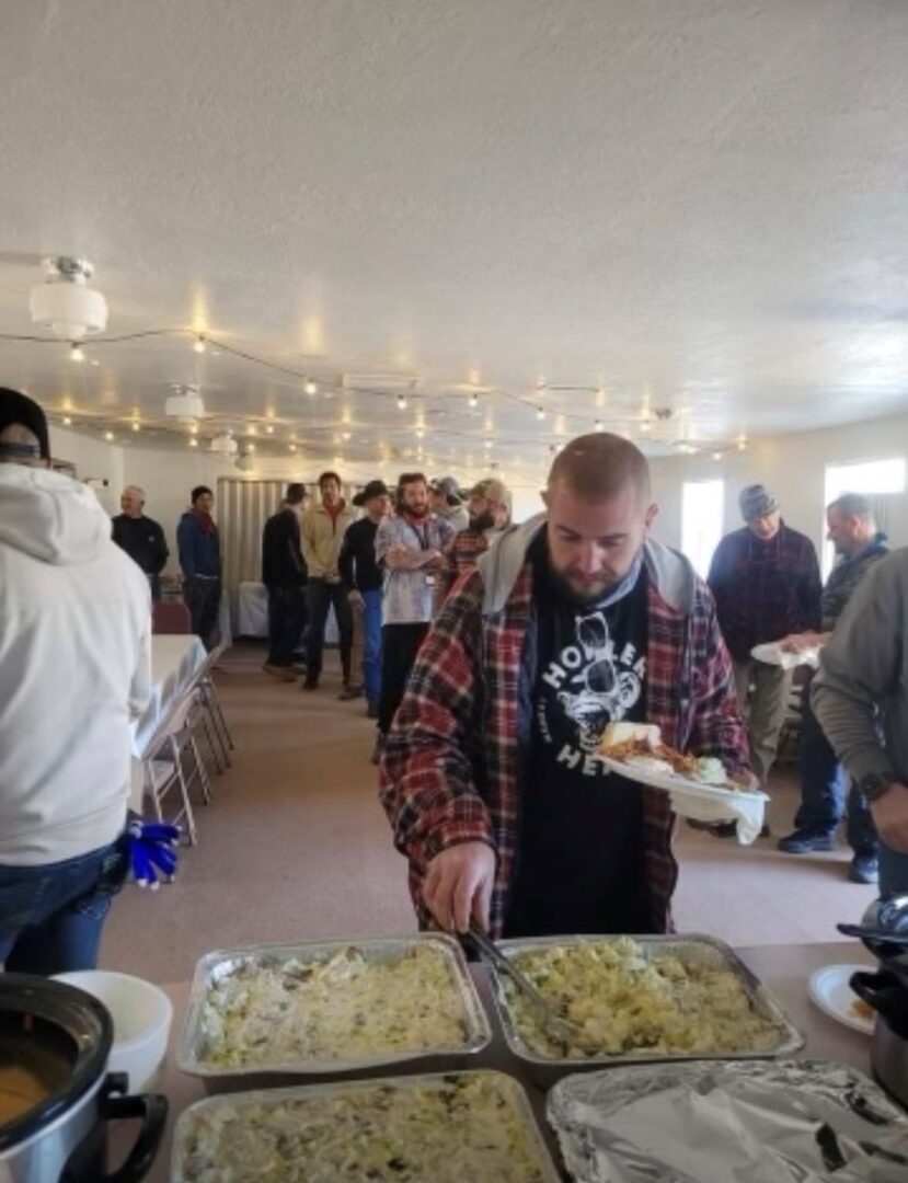 A man standing in front of a table with food.