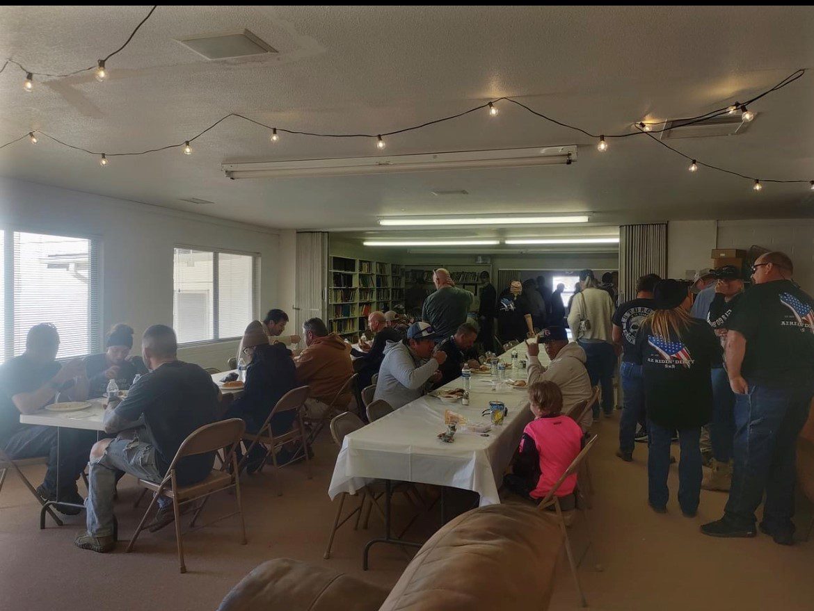 A group of people sitting at tables in a room.