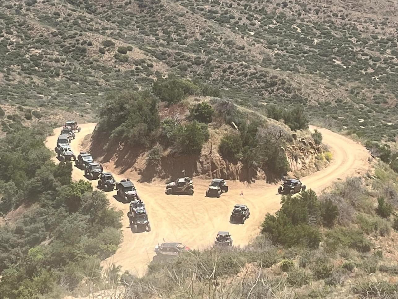 A group of vehicles parked in the middle of a field.