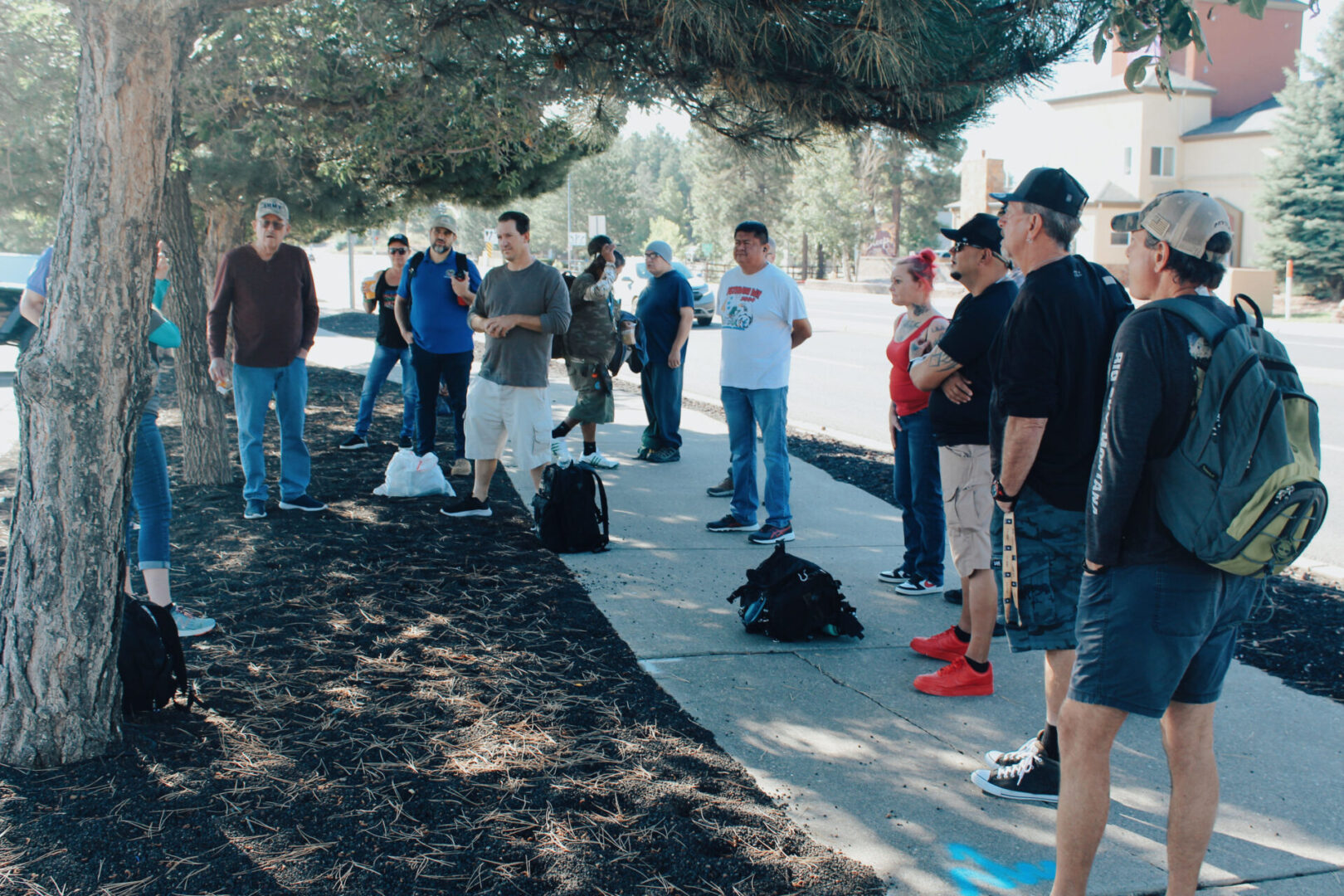 A group of people standing on the side walk