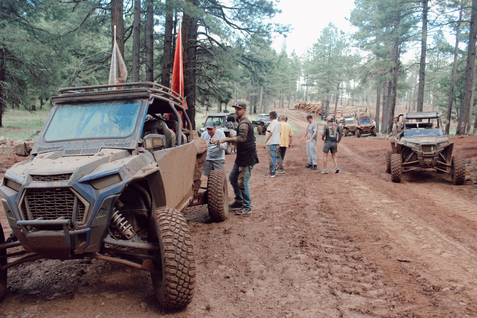 A group of people standing around a jeep.