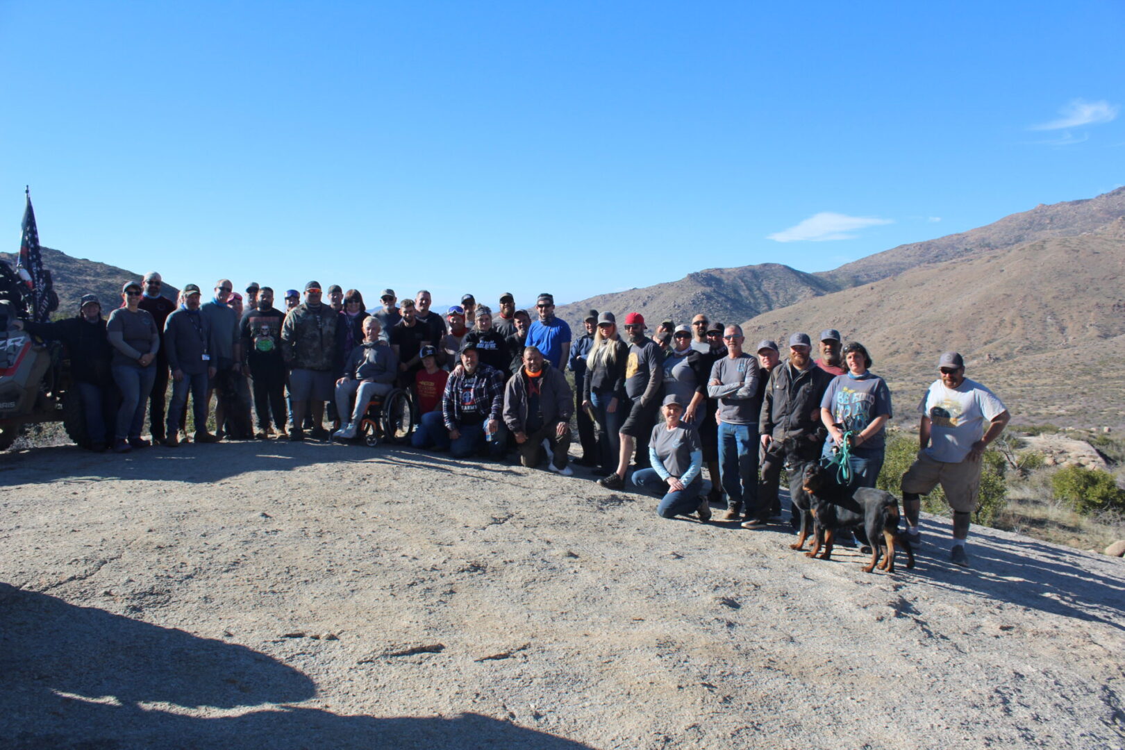 A group of people standing on top of a hill.