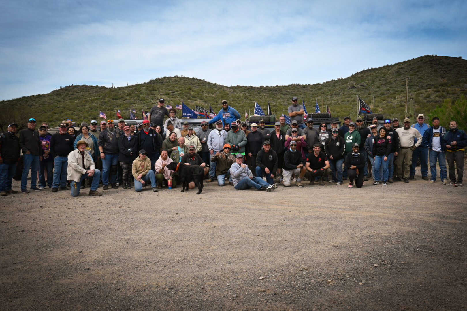 A group of people standing in the dirt.