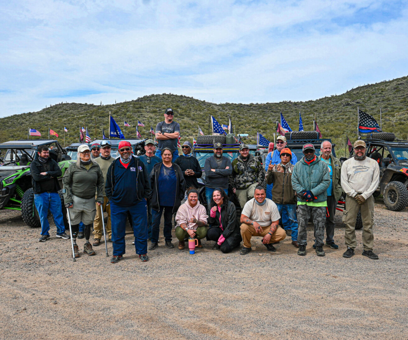 A group of people standing in the dirt.