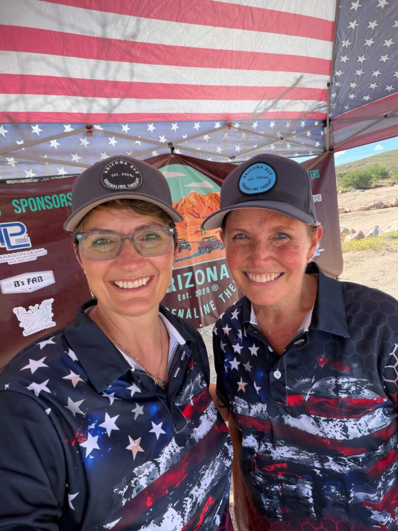 Two people smiling wearing American flag shirts