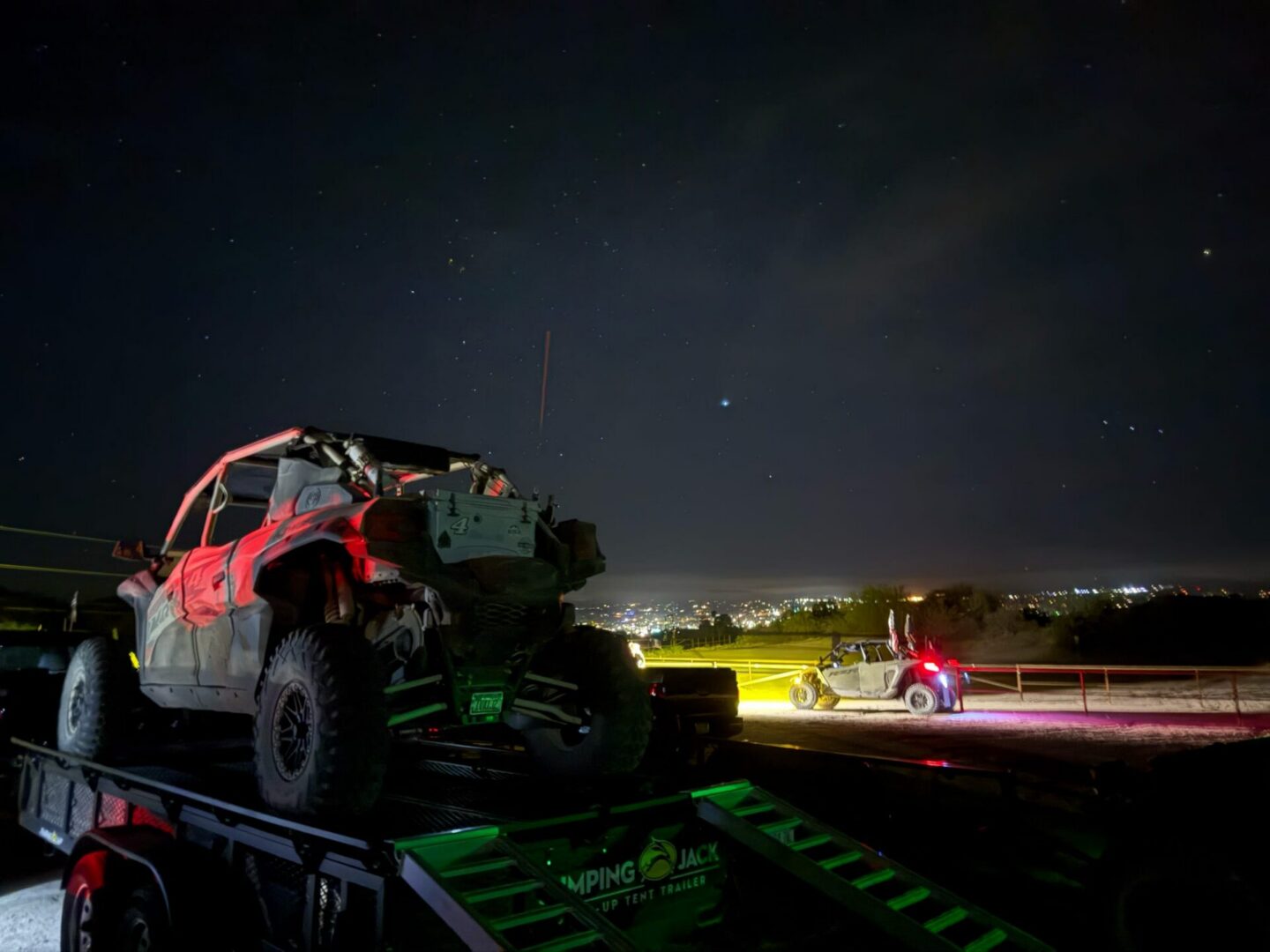 Off-road vehicle on trailer at night