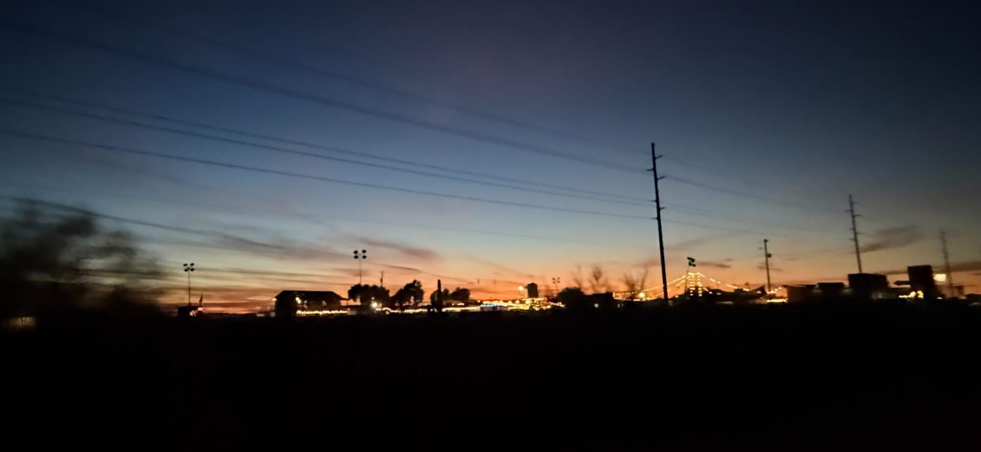 Sunset silhouette with power lines and storefronts