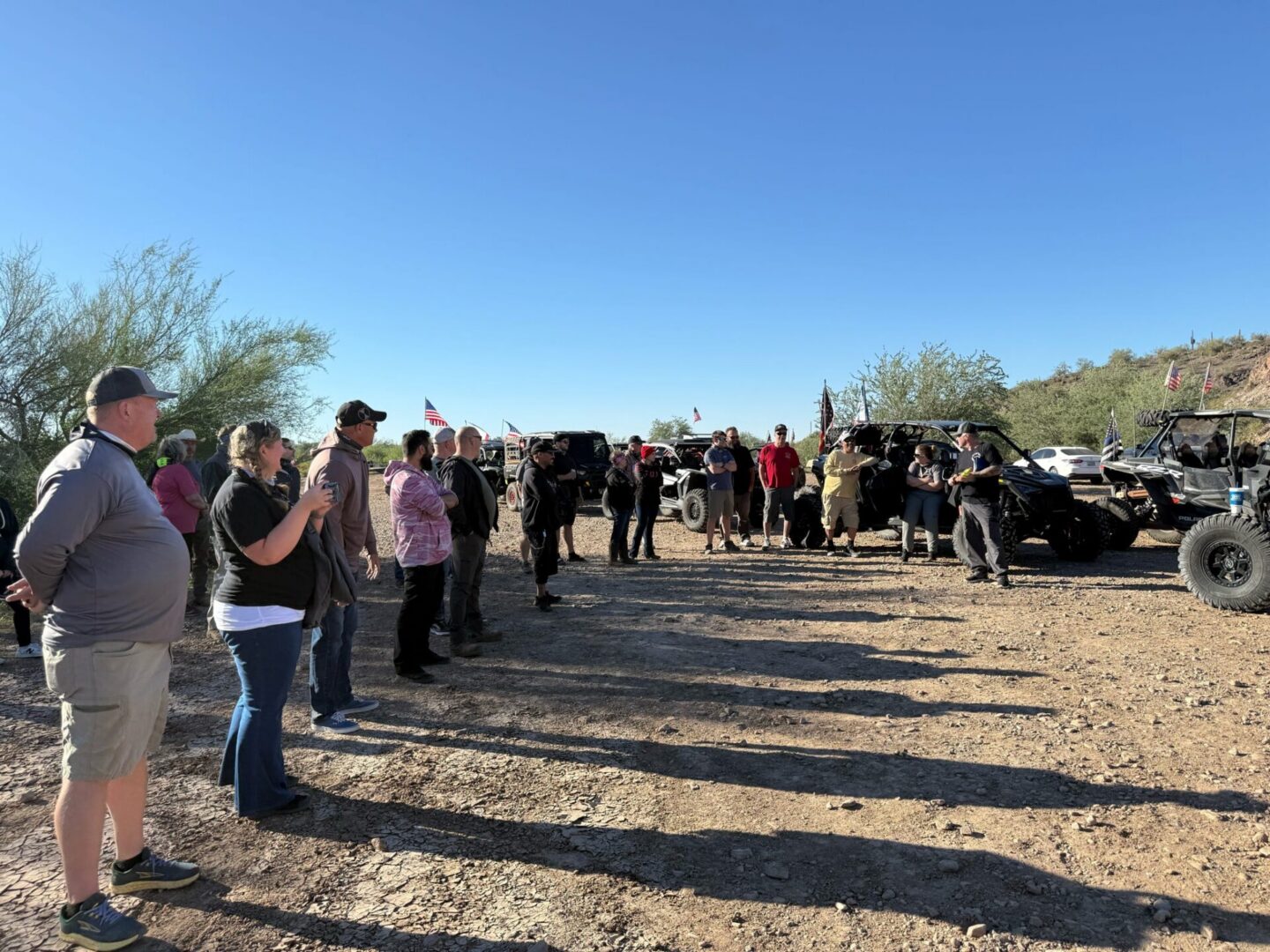 Group of people gathered near off-road vehicles