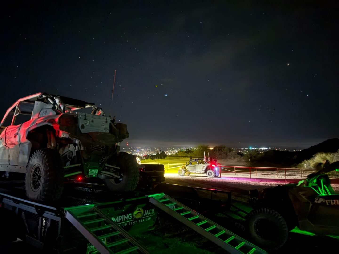 UTVs on trailers against starry night skyline