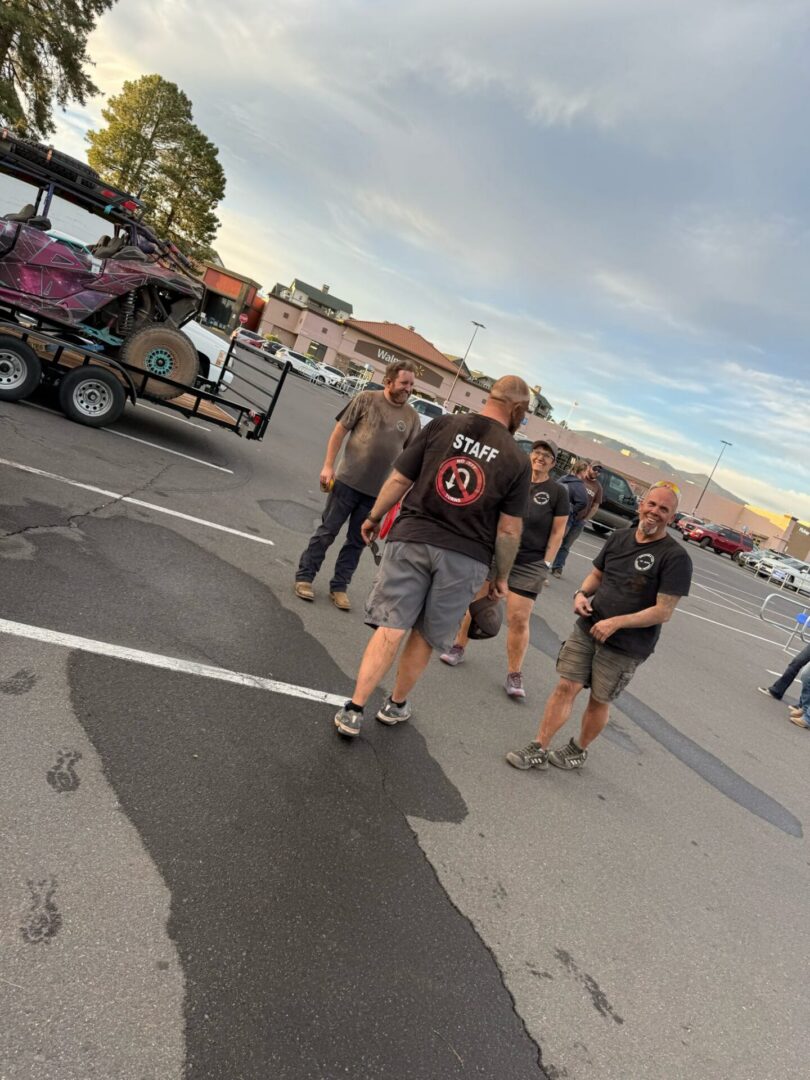 Staff and crew talking by off-road buggy