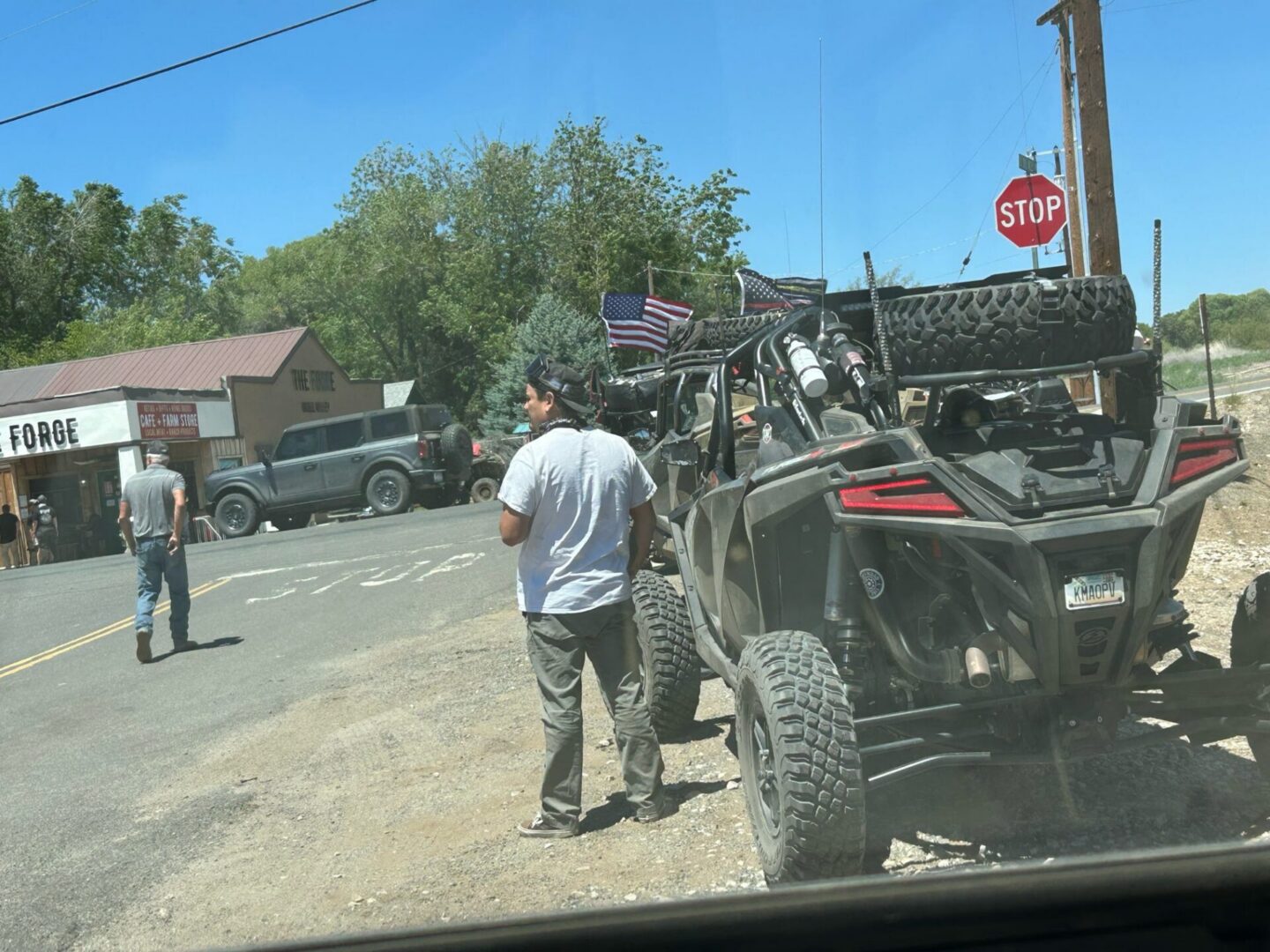 UTV and people parked near stop sign