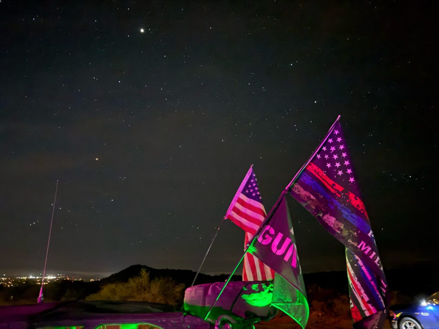 American flag and banners under starry sky