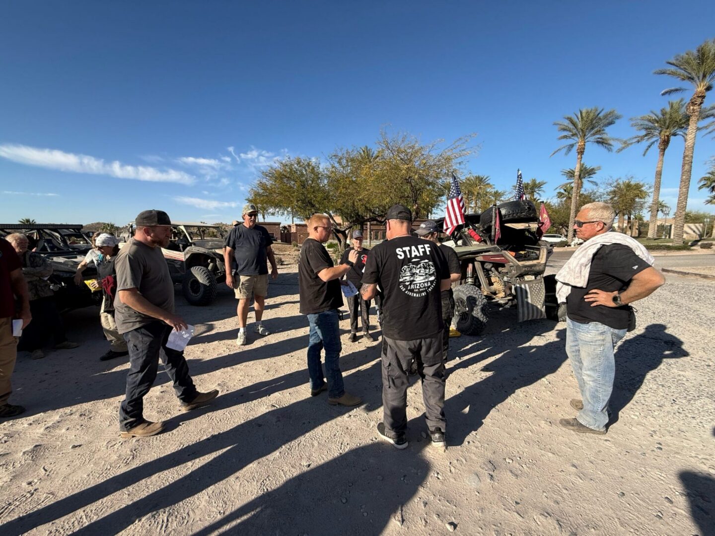 Group of off-road riders gathered near UTVs
