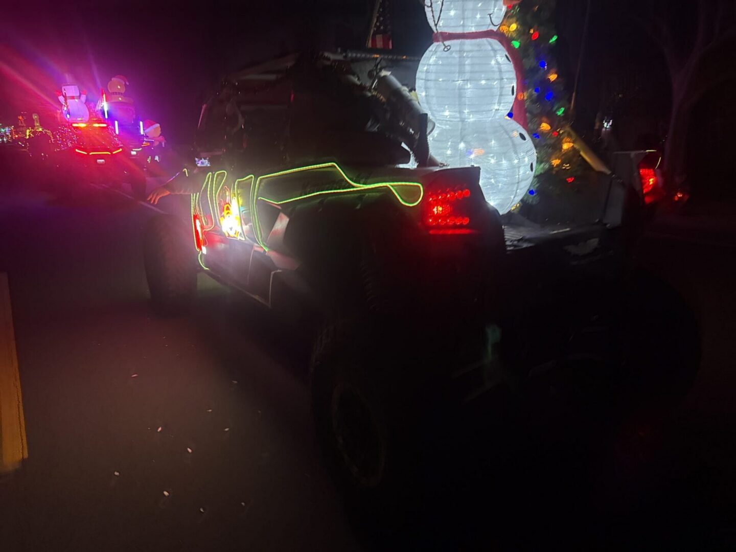 Holiday parade truck with illuminated snowman