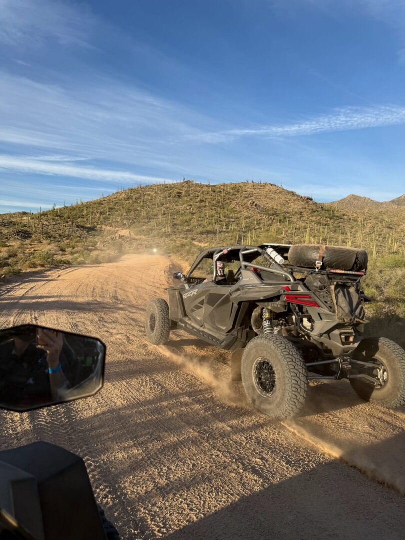 Off-road UTV kicking up dust in desert