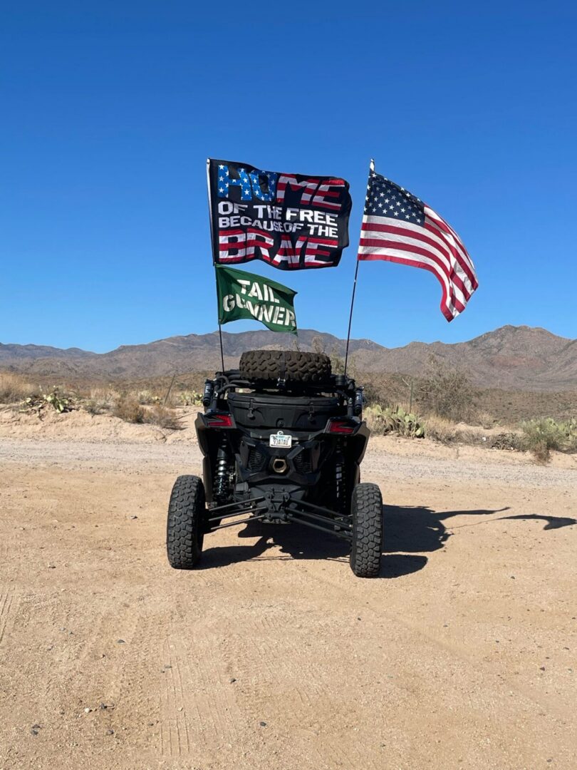 Off-road UTV flying American flags in desert