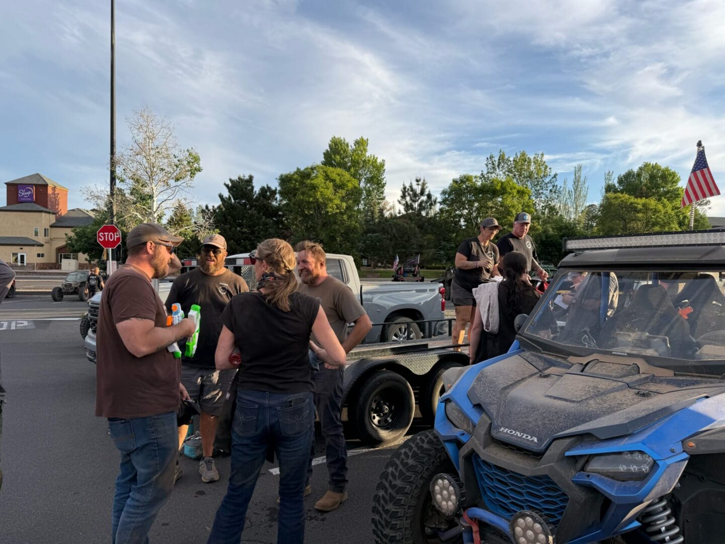 Group of people by blue off-road vehicle