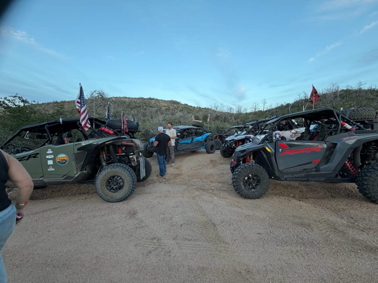 Off-road UTVs parked on desert trail