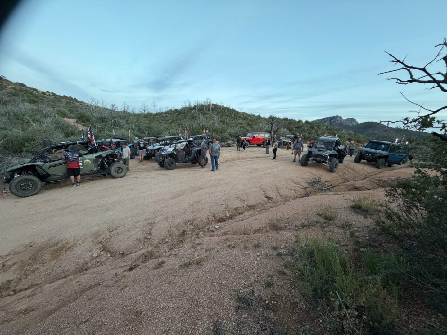 Group of off-road vehicles parked on desert trail