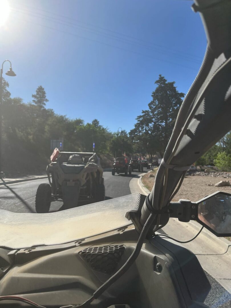 UTV convoy driving on sunny road