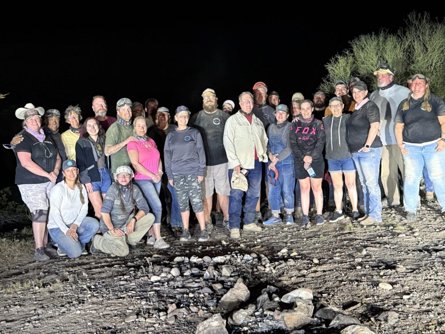 Large group of people standing outdoors at night