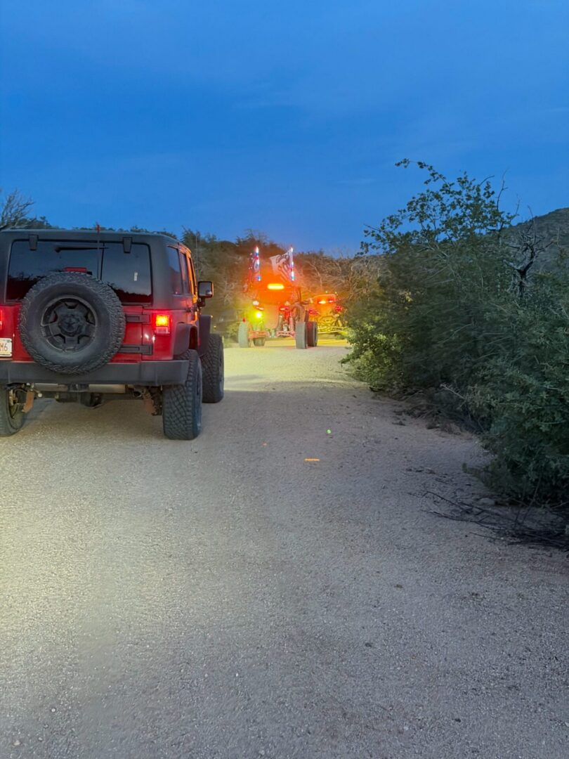 Jeep parked on desert road at dusk