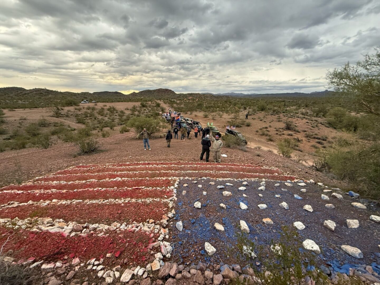 Group walking past painted rock American flag
