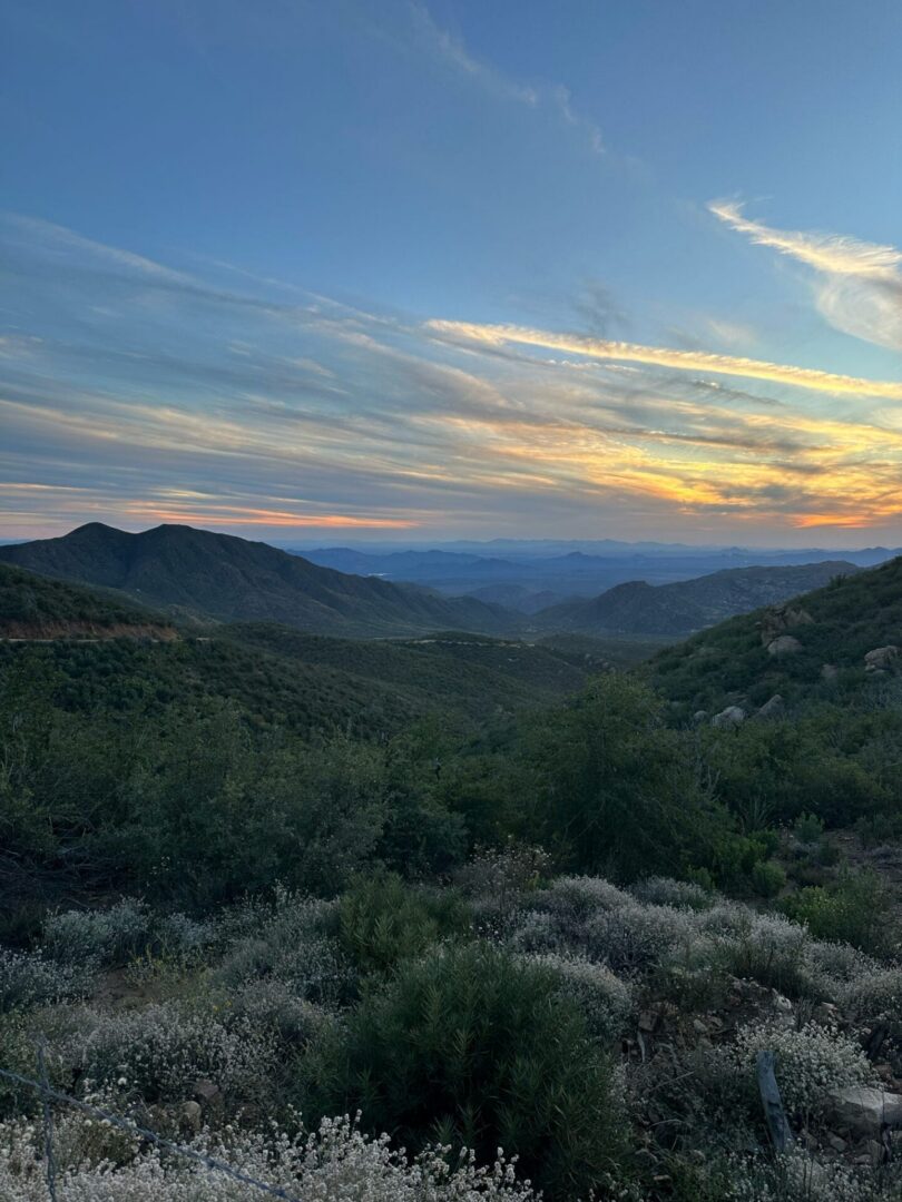 Sunset over layered mountains and shrubland