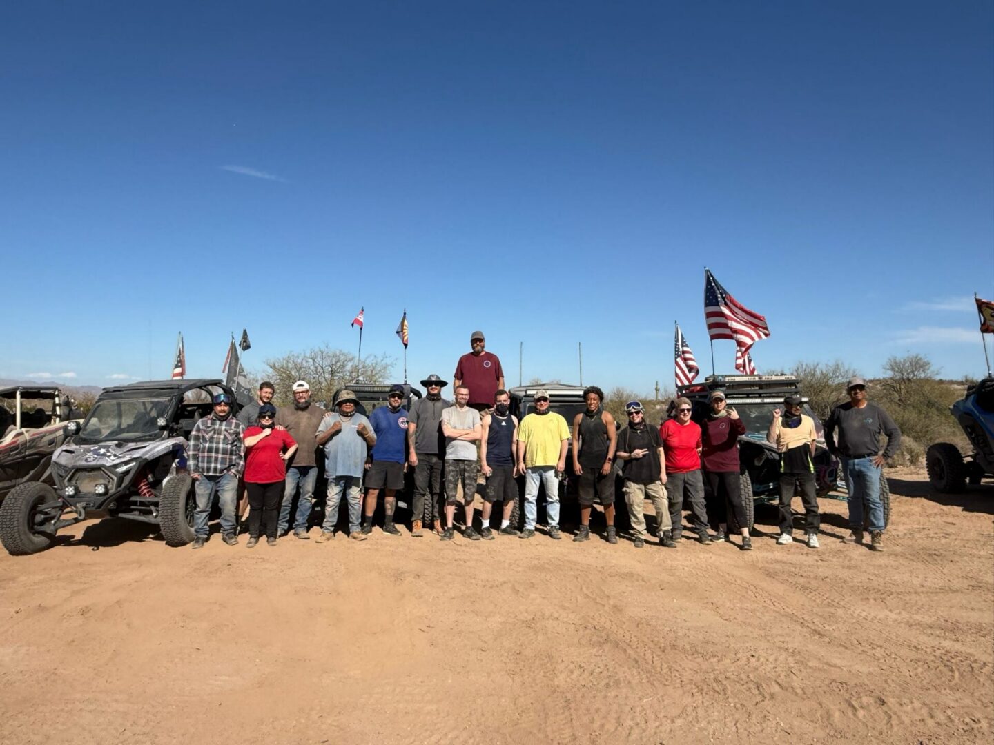 Group of people with off-road vehicles and flags