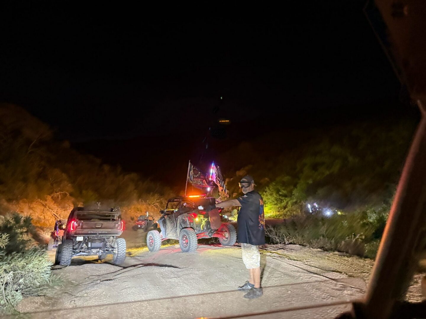 Night off-road vehicles with person on dirt road