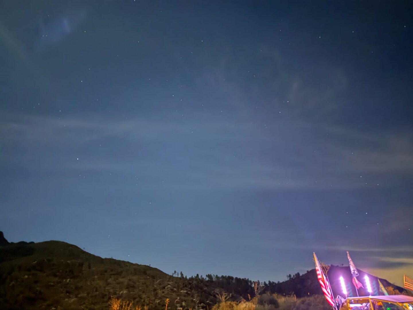 Illuminated American flags beneath starry sky