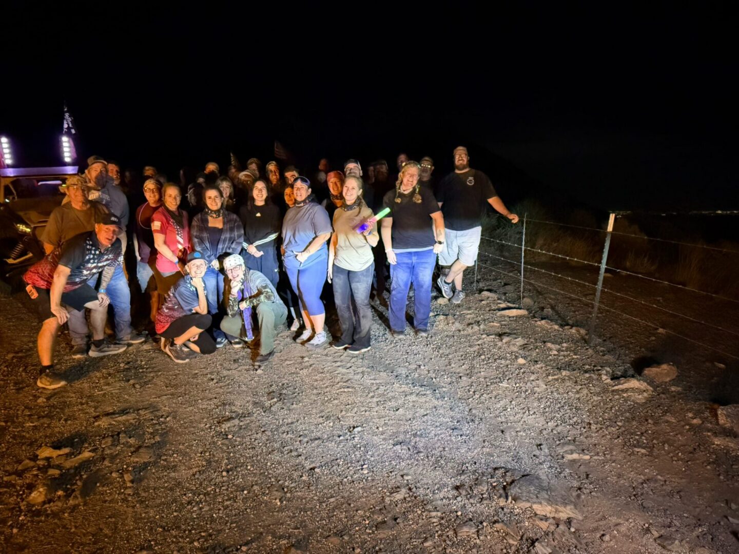 Group of people posing outdoors at night