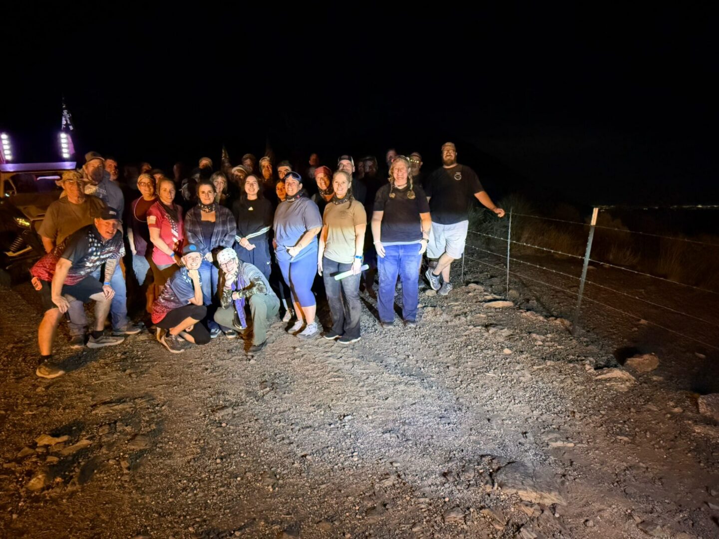 Large group gathered outdoors at night
