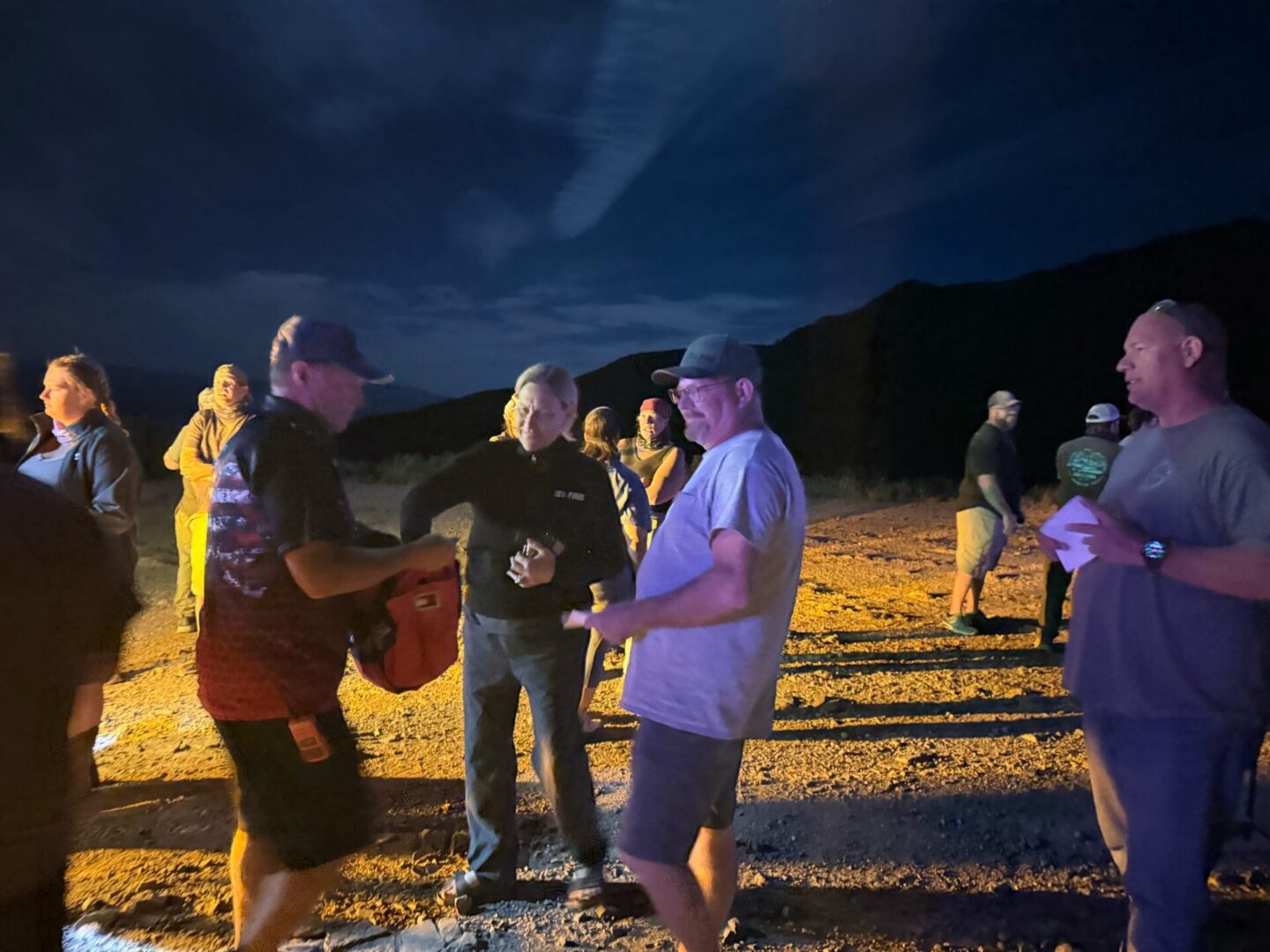 Group of people standing outdoors at night