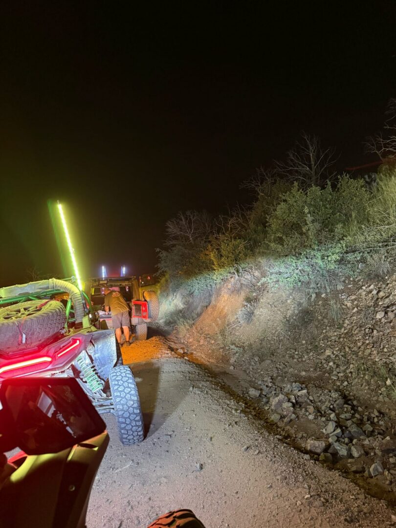 Nighttime off-road UTVs on rocky trail