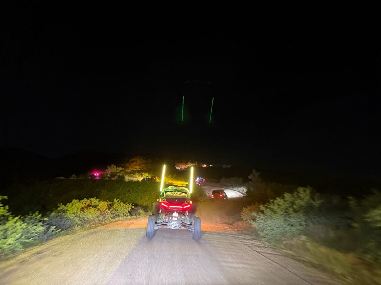 Off-road UTVs driving on dirt trail at night