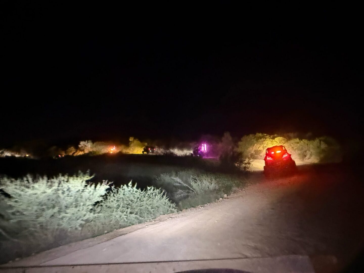 Off-road vehicles on desert road at night