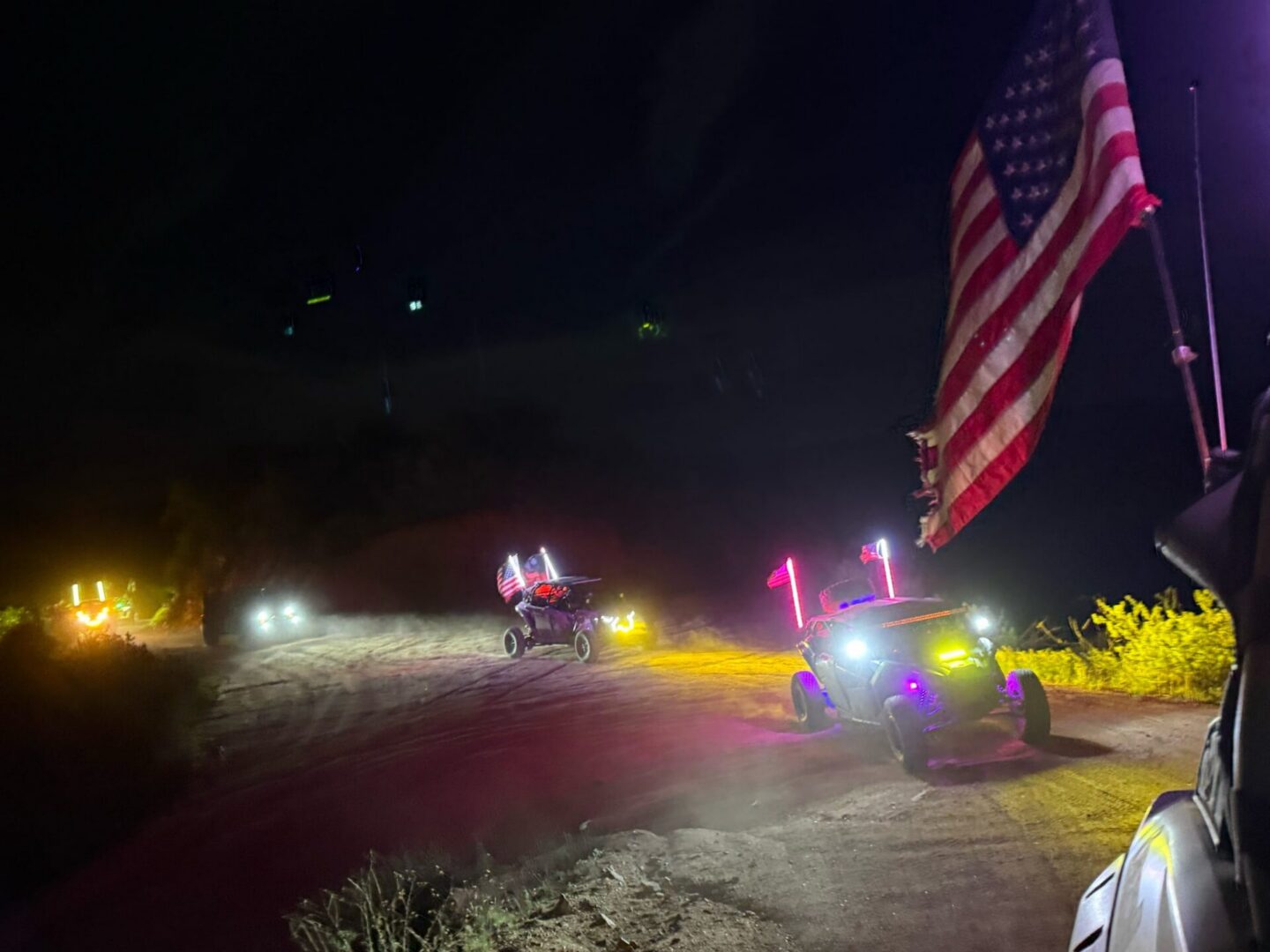 Off-road vehicles with lights and American flag