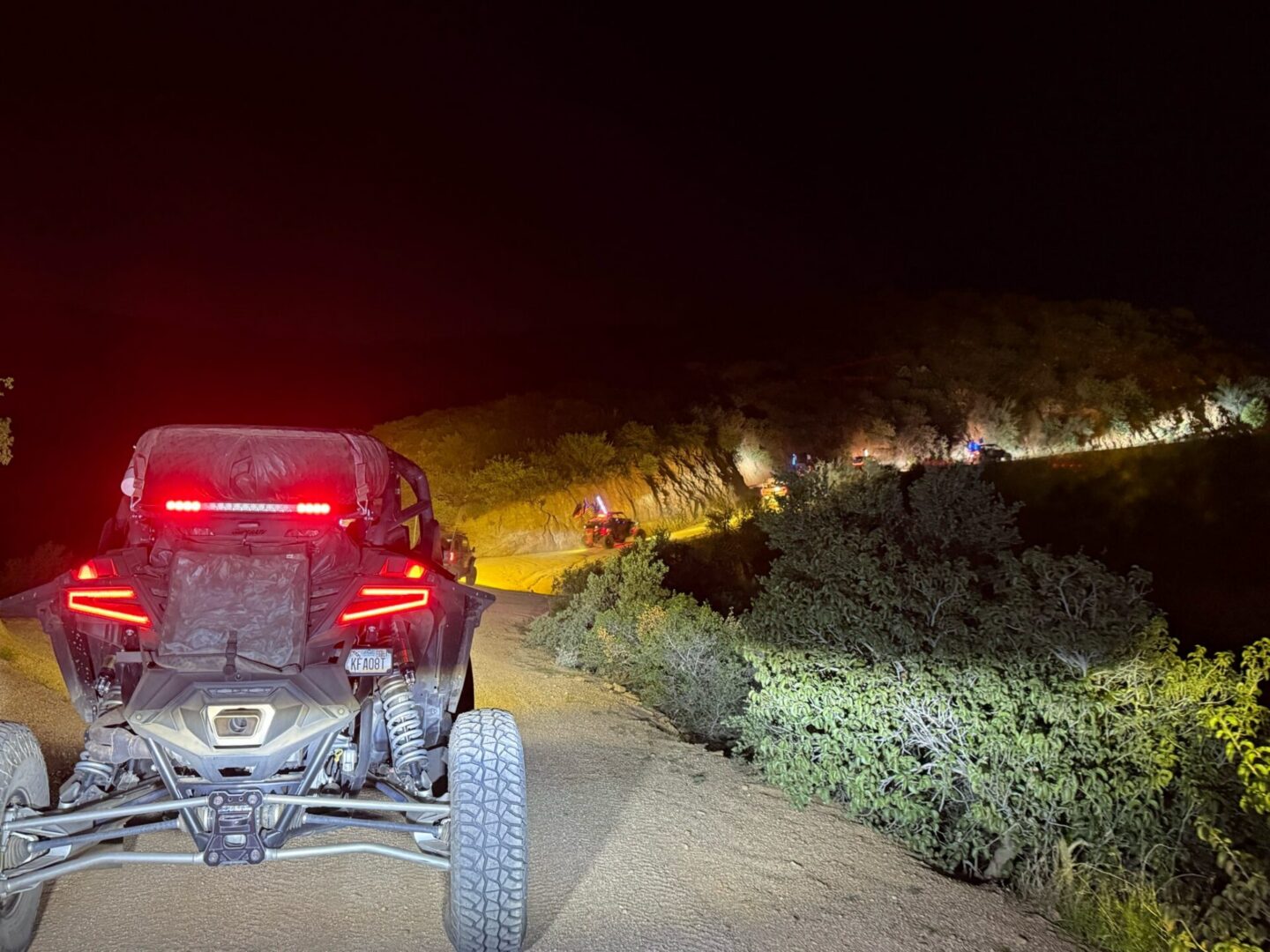Nighttime off-road UTV on illuminated trail